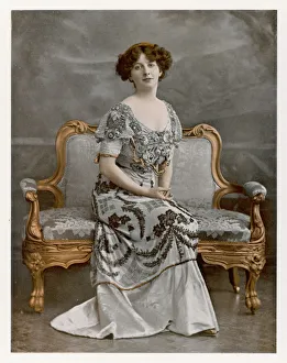 <b class=qtipBold><figcaption>Female Type on Settee</figcaption></b><br>An elegant woman sits on a sofa whose upholstery matches her dress.<br><em>© Mary Evans Picture Library</em> Female Type on Settee