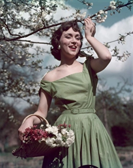 <b class=qtipBold><figcaption>Fifties Summer Frock</figcaption></b><br>Outdoors girl wears a tailored summer frock with tie shoulder straps, square neckline, self- coloured belt & a full skirt with narrow pleats attached to a yoke.<br><em>© Mary Evans Picture Library</em> Fifties Summer Frock