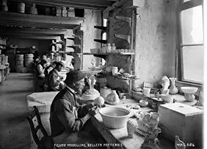 Prints of Figure Modelling, Belleek Potteries - an interior shot showing a row of men modelling china. (Location: Northern Ireland: County Fermanagh: Belleek). Date: circa early 1900s Fermanagh Prints: Belleek Potteries Figure Modelling Print, circa early 1900s