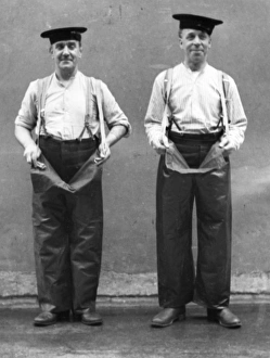Two firemen modelling waterproof leggings Two firemen modelling waterproof leggings