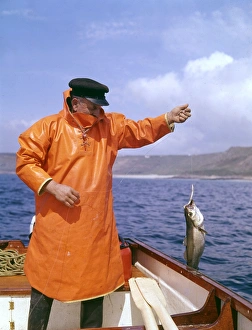 Fisherman with pollock, Lands End, Cornwall Fisherman with pollock, Lands End, Cornwall
