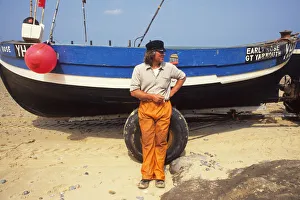 Fisherman waits for tide, Happisburgh, Norfolk Fisherman waits for tide, Happisburgh, Norfolk