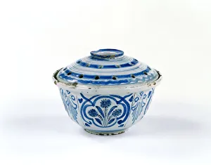 <b class=qtipBold><figcaption>Flower bowl</figcaption></b><br>Tin-glazed earthenware flower or pot-pourri holder and lid, with blue and manganese painted decoration of stylised floral sprays set within quatrefoils. The top is pierced with a central hole and twenty-six smaller holes, thought to be made in London c.1690-1710. Date: c.1690-1710<br><em>© The Geffrye Museum of the Home / Mary Evans Picture Library</em> Flower bowl
