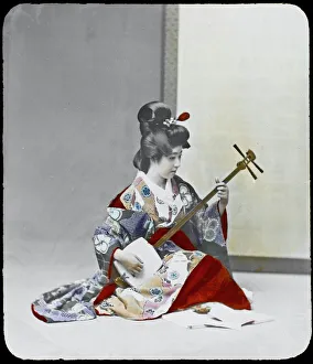 <b class=qtipBold><figcaption>Geisha Playing Shamisen</figcaption></b><br>A young geisha practises on her shamisen.<br><em>© Mary Evans Picture Library</em> Geisha Playing Shamisen