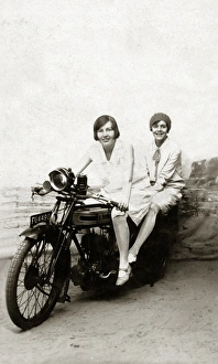 Girls on a 1922 Triumph SD motorcycle in studio Girls on a 1922 Triumph SD motorcycle in studio