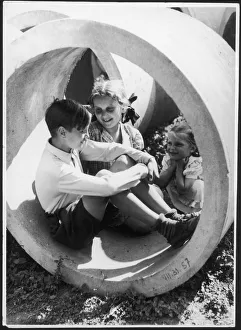 <b class=qtipBold><figcaption>Girls Admire a Boy</figcaption></b><br>Two little girls appear to have a crush on the little boy sitting in this concrete ring.<br><em>© Mary Evans Picture Library</em> Girls Admire a Boy