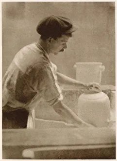 Glazing ware: a dipper at work in the dipping room. Date: 1913 Glazing ware: a dipper at work in the dipping room. Date: 1913
