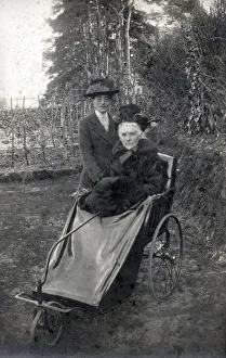 A rather grand-looking elderly lady going out for a spin in her bath chair along with her A rather grand-looking elderly lady going out for a spin in her bath chair along with her