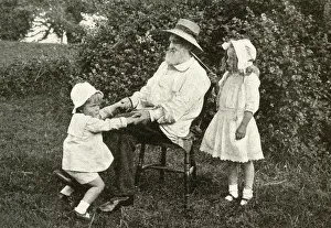 Grandfather and two children in a garden, England Grandfather and two children in a garden, England