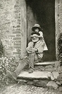 Grandfather and granddaughter in a doorway, England Grandfather and granddaughter in a doorway, England