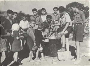 Greek boy scouts supplying water to children Greek boy scouts supplying water to children