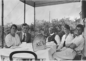 Group of five holidaymakers at a table Group of five holidaymakers at a table
