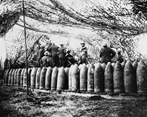 <b class=qtipBold><figcaption>Howitzer 1917</figcaption></b><br>12 inch Howitzer gun and ammunition under camouflage netting at the Battle of Arras on the Western Front in France during World War I in April 1917<br><em>© Mary Evans/Robert Hunt Collection</em> Howitzer 1917