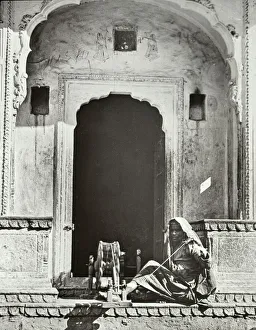 India - An Indian Woman Spinning in an ornate entrance India - An Indian Woman Spinning in an ornate entrance