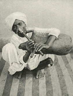 Indian musician plays noseflute and bagpipes simultaneously Indian musician plays noseflute and bagpipes simultaneously