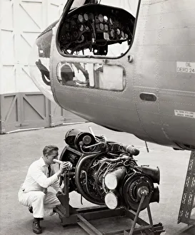 Inspecting engine beside Belvedere helicopter Inspecting engine beside Belvedere helicopter