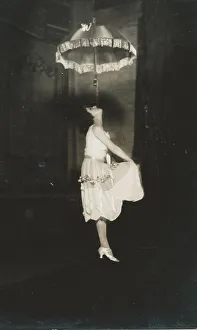 <b class=qtipBold><figcaption>Iron jaw act</figcaption></b><br>Unidentified iron jaw act. The performer held one end of a leather strap with their teeth while the other end of the strap had a hook which was attached to a trapeze or, in this case, to a parasol high in the air. The artistes performed acrobatics while hanging from the strap. Date: circa 1920s<br><em>© MonoMania Images / Mary Evans Picture Library</em> Iron jaw act