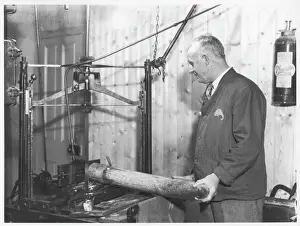 Prints of A man prepares an ivory tusk in his workshop African Elephant Prints: Ivory Tusk Preparation Print