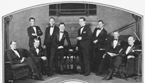 Jack Virgil - standing by the table - with his orchestra Jack Virgil - standing by the table - with his orchestra