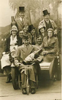 A jolly group of holidaymakers pose for a photograph with prop beer bottle A jolly group of holidaymakers pose for a photograph with prop beer bottle