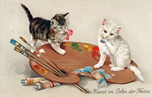 Two kittens on an artist's palette on a greetings postcard Two kittens on an artist's palette on a greetings postcard