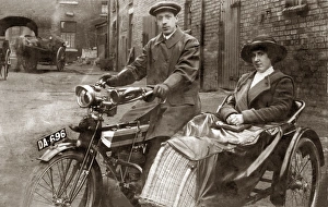 Lady & gentleman sitting on a 1910 Triumph motorcycle Lady & gentleman sitting on a 1910 Triumph motorcycle