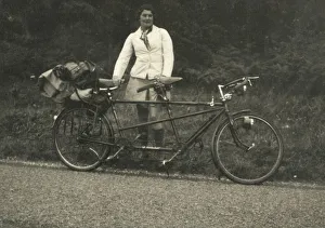 A lady kitted out for a cycling trip in warm coat and long socks standing alongside a A lady kitted out for a cycling trip in warm coat and long socks standing alongside a