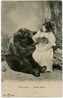 A lady in Traditional Bernaise costume posing with a bear A lady in Traditional Bernaise costume posing with a bear