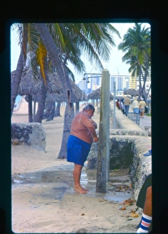 Large man taking a shower, Florida, USA Large man taking a shower, Florida, USA