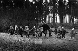 A line of small children are led to Santas grotto A line of small children are led to Santas grotto