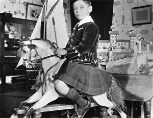 Rides Collection: Little boy on rocking horse