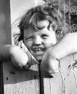 Little girl behind a fence, Balham, SW London