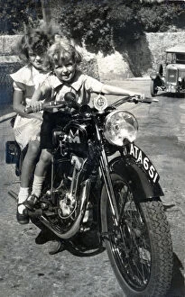 Pretending Gallery: Two little girls sitting on 1934 Matchless motorcycle
