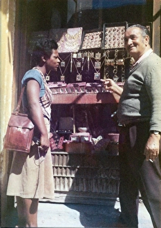 Lorna Holder talking to a shopkeeper outside jewellery shop Lorna Holder talking to a shopkeeper outside jewellery shop