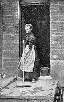 Broom Gallery: A maid-of-all-work sweeps a step, c. 1900