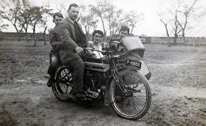 Man & family on 1915 Triumph motorcycle Man & family on 1915 Triumph motorcycle
