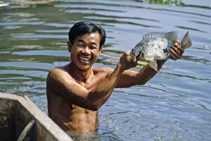 Bare Chested Gallery: Man with fish, Bangkok