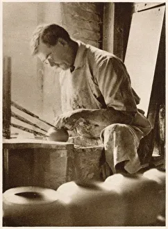 A man forming articles upon the potter's wheel: a thrower. Date: 1913 A man forming articles upon the potter's wheel: a thrower. Date: 1913