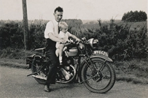 Man and little boy on 1933 Triumph motorcycle Man and little boy on 1933 Triumph motorcycle