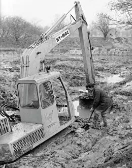 Mechanical Gallery: Man with mechanical digger in a muddy field