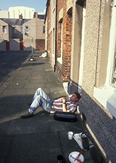 Man snoozing outside his house in Stewart Street, Barrow in Man snoozing outside his house in Stewart Street, Barrow in