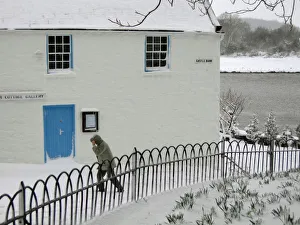 Man walks past the Harbour Cottage Gallery in Kirkcudbright Man walks past the Harbour Cottage Gallery in Kirkcudbright