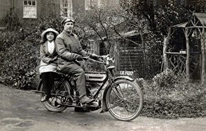 Man & young girl on a 1911 Triumph motorcycle Man & young girl on a 1911 Triumph motorcycle