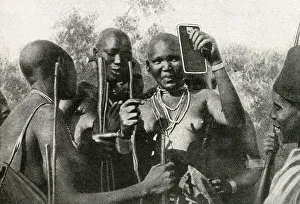 Masai women of East Africa looking in a mirror Masai women of East Africa looking in a mirror