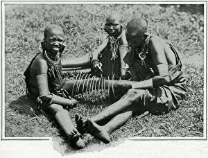 Masai young women adjusting iron wire