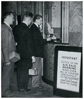 Three men at the cinema with their gas masks, September 1939 Three men at the cinema with their gas masks, September 1939