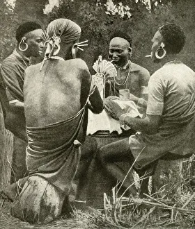 Four men playing cards, Kenya, East Africa Four men playing cards, Kenya, East Africa