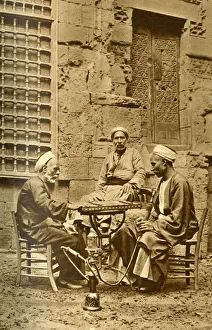 Men playing game of draughts in a courtyard, Egypt Men playing game of draughts in a courtyard, Egypt