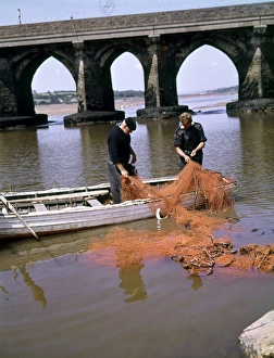 Two men repairing fishing nets, Bideford, Devon Two men repairing fishing nets, Bideford, Devon