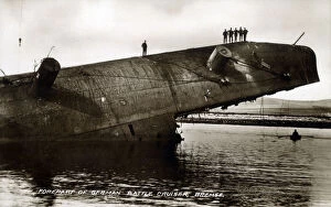 Men stand on forepart of part-submerged German Battlecruiser